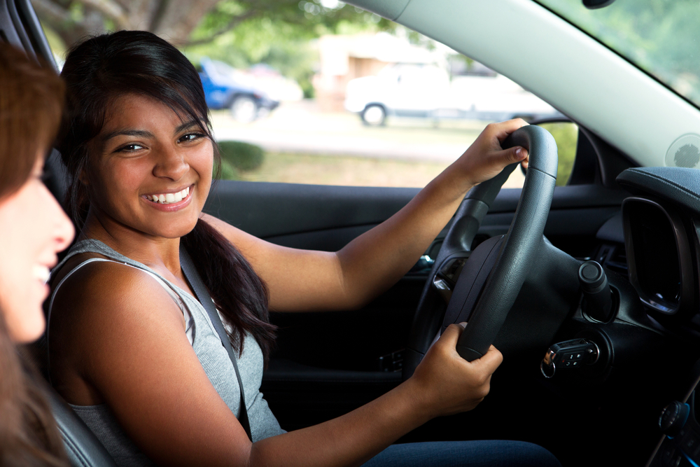 teen girl driving for the first time with a friend