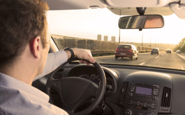 front view of freeway with cars from the inside of a cars drivers seat