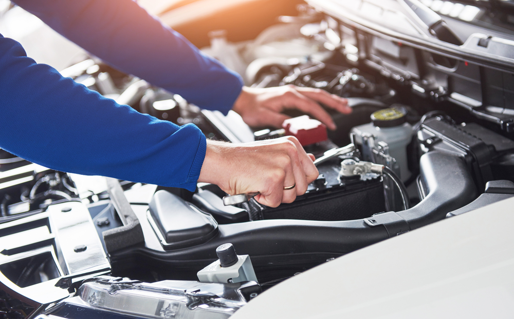 mechanic hands fixing car in texas