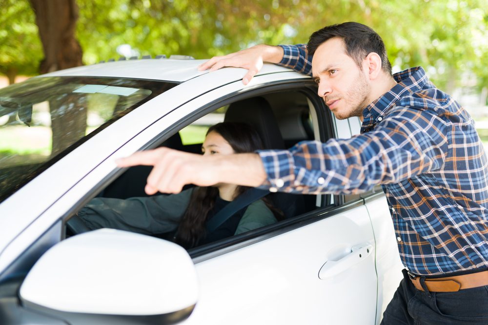 parent teaching teenager to drive