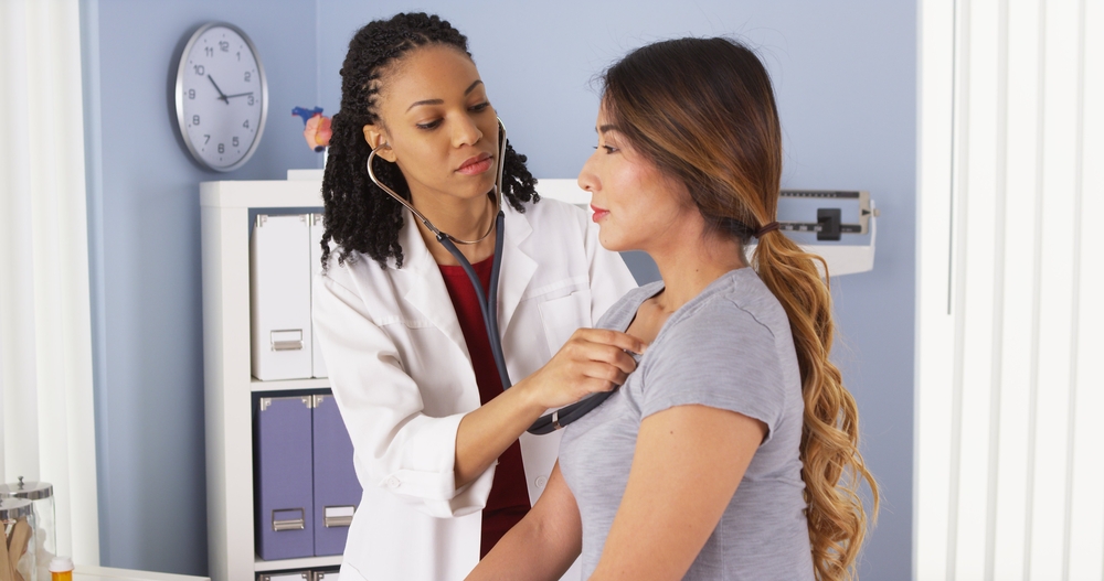 woman getting physical at doctor's office