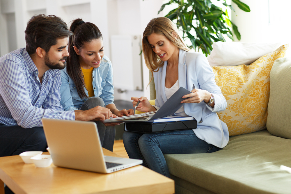 insurance agent going over insurance information with couple