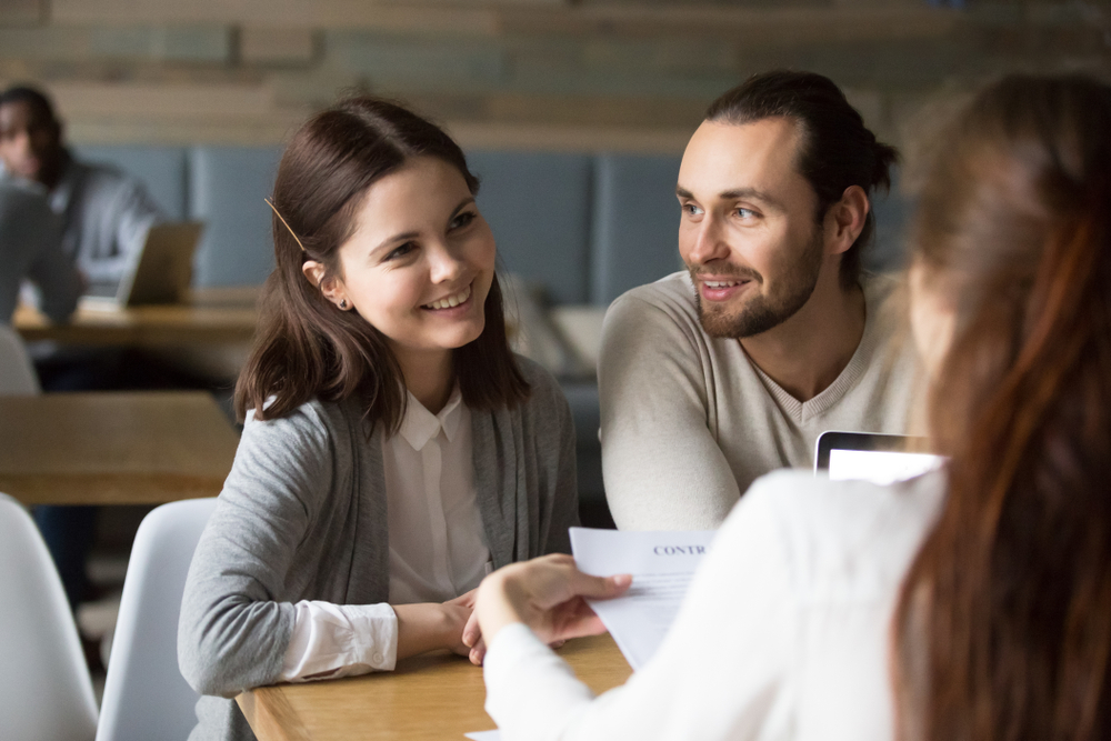 young couple talking to insurance agent