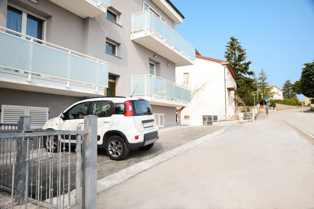 image of a car parked by apartment building